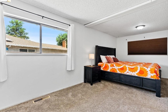 carpeted bedroom with a textured ceiling