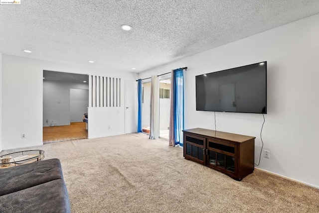 living room with carpet floors and a textured ceiling