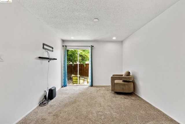 unfurnished room with carpet floors and a textured ceiling