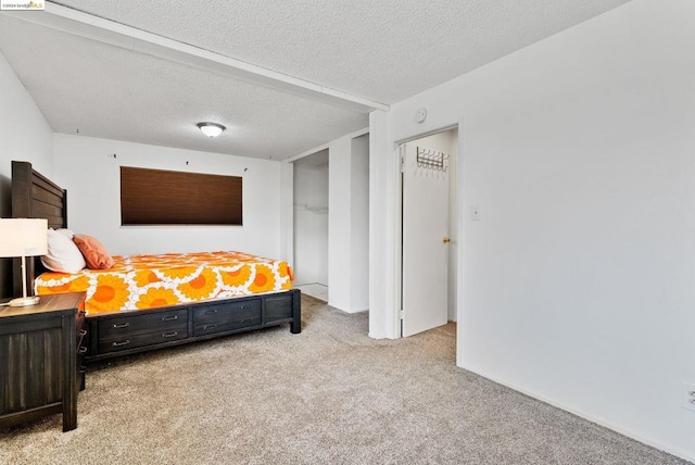 carpeted bedroom featuring a textured ceiling