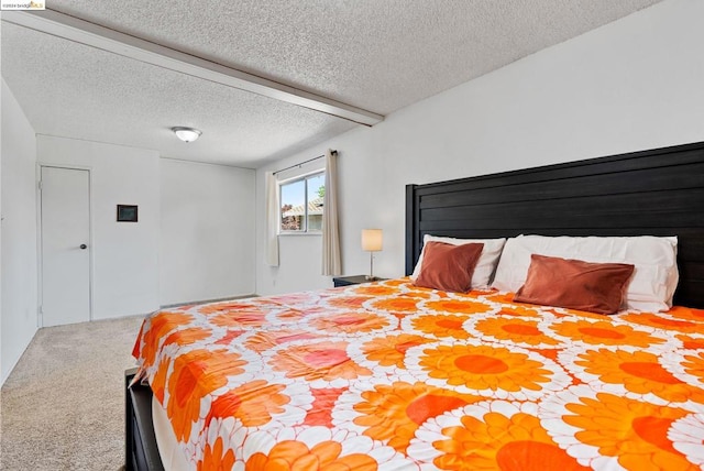 bedroom featuring a textured ceiling and carpet floors