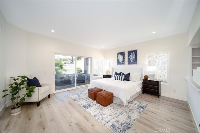 bedroom featuring access to exterior and light hardwood / wood-style flooring