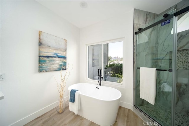 bathroom featuring independent shower and bath and wood-type flooring