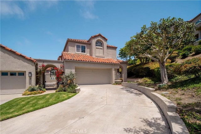 mediterranean / spanish home with a garage