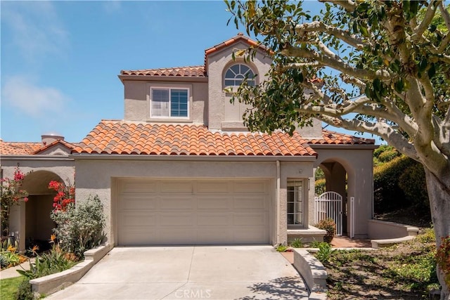 mediterranean / spanish-style home with a garage