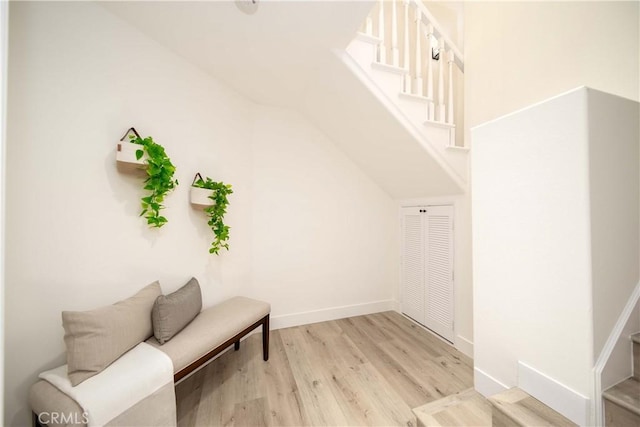 sitting room featuring light hardwood / wood-style floors and lofted ceiling