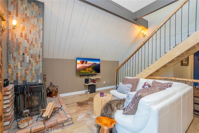 living room featuring light hardwood / wood-style floors and lofted ceiling with beams