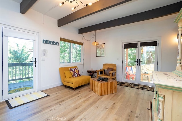 entryway featuring beamed ceiling, a wealth of natural light, light hardwood / wood-style flooring, and french doors