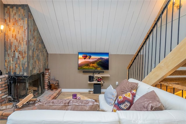 living room with a fireplace, hardwood / wood-style flooring, and vaulted ceiling