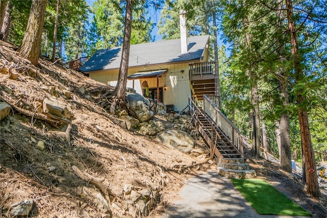 view of home's exterior with a wooden deck