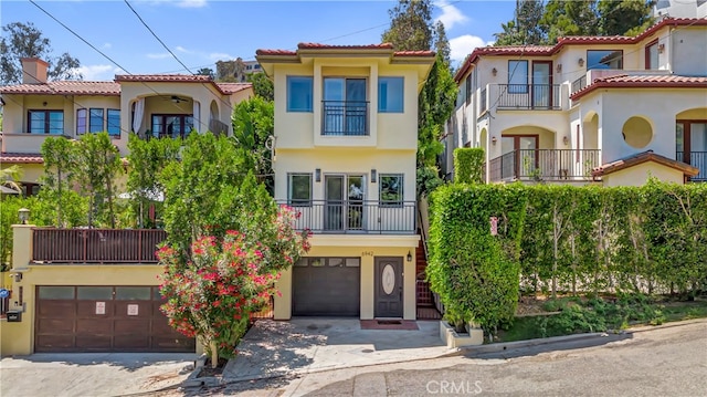 mediterranean / spanish house with a balcony and a garage