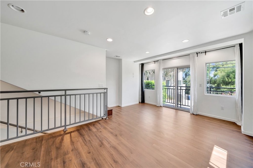 spare room with hardwood / wood-style flooring