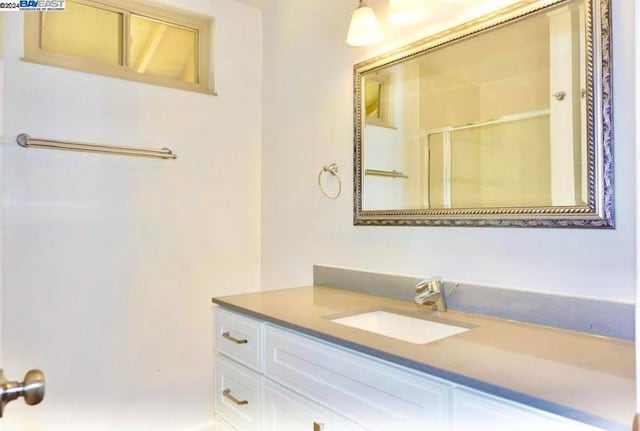 bathroom with an enclosed shower and vanity