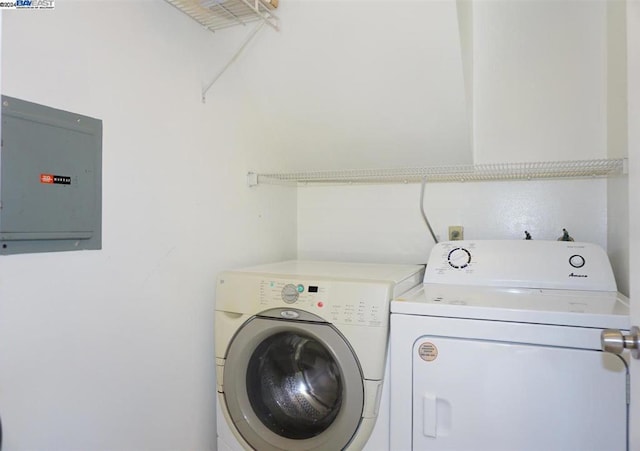 laundry room featuring electric panel and washing machine and dryer