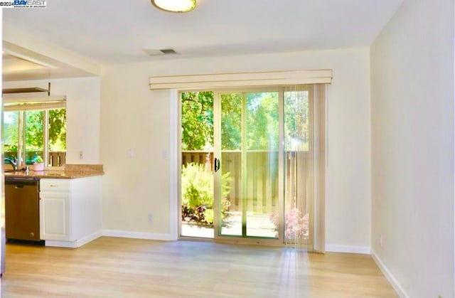 unfurnished dining area with light wood-type flooring