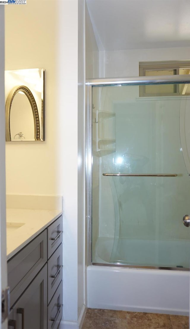 bathroom featuring enclosed tub / shower combo and vanity