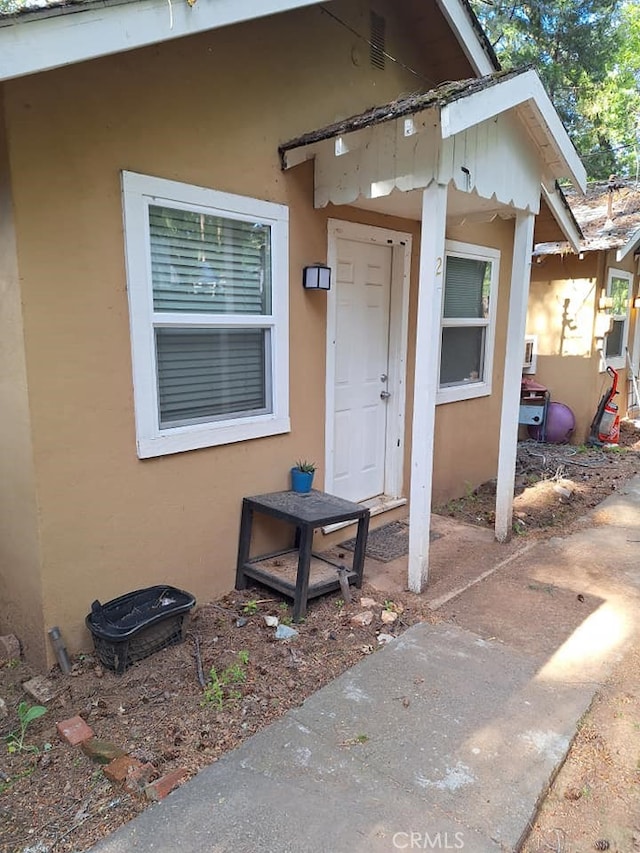 property entrance with stucco siding