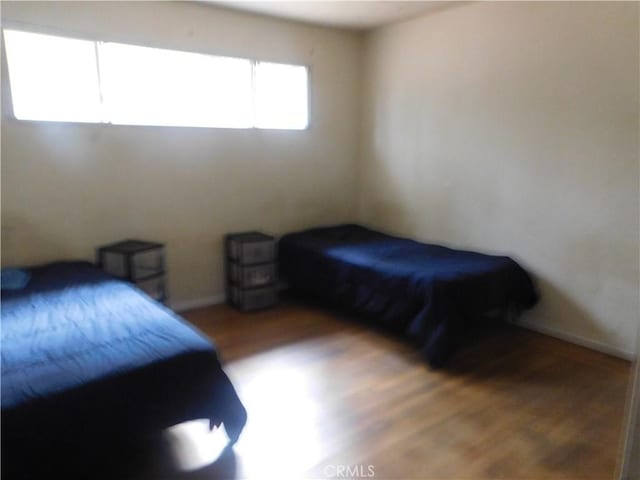 bedroom with dark wood-style floors