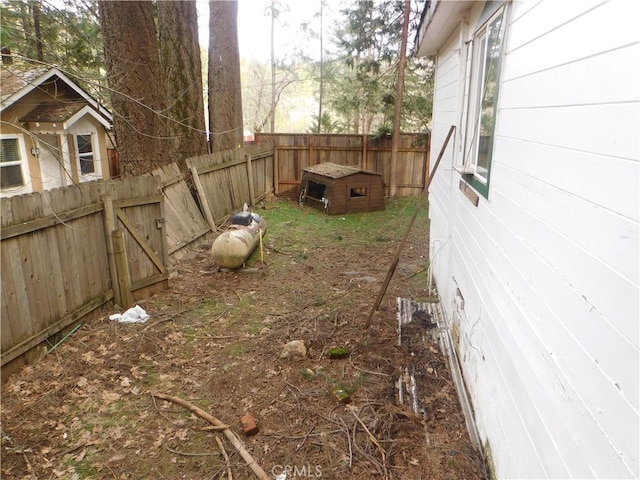 view of yard with an outbuilding and a fenced backyard