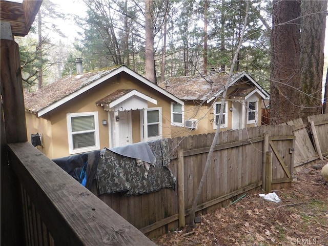 exterior space featuring fence and stucco siding