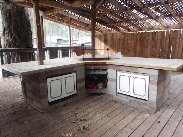 wooden deck featuring outdoor dry bar