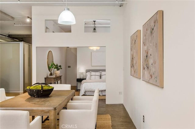 interior space with a towering ceiling and concrete floors