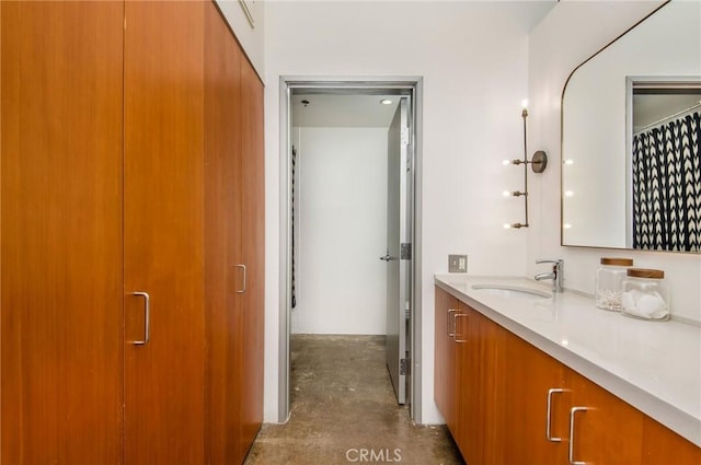 bathroom featuring vanity and concrete flooring