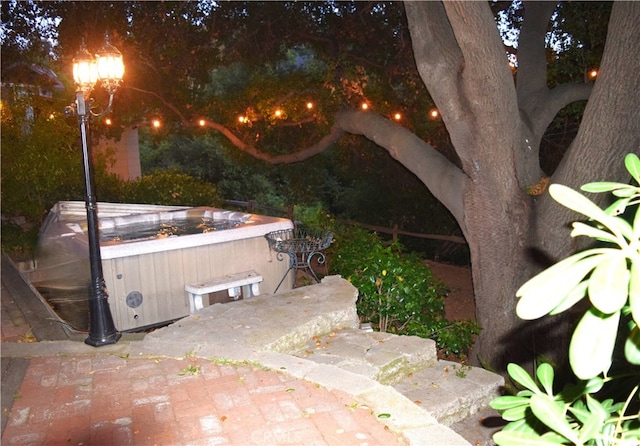 view of patio / terrace with a hot tub