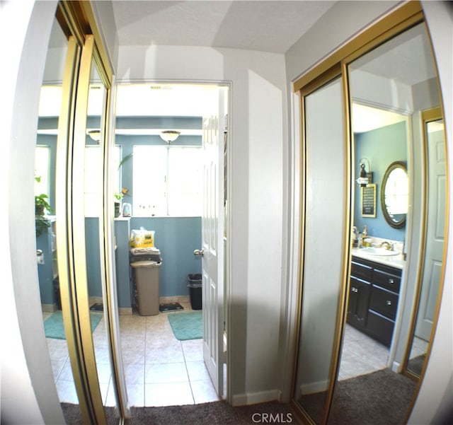 corridor with light tile patterned flooring