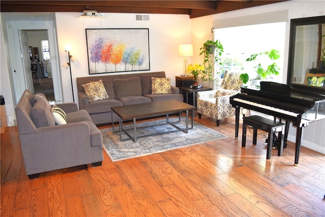 living room featuring hardwood / wood-style flooring and beamed ceiling