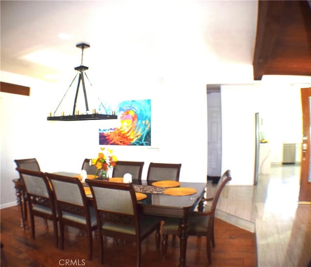 dining area featuring an inviting chandelier and dark hardwood / wood-style flooring