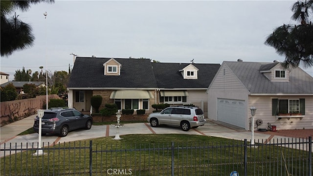 new england style home featuring a garage and a front lawn