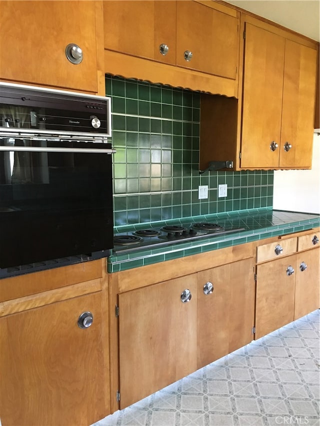 12100 Colima Rd, Whittier, CA 90604 - kitchen featuring black appliances, tile counters, and decorative backsplash