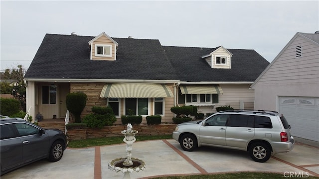 cape cod house with a garage