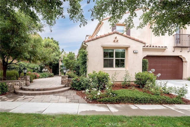 mediterranean / spanish home with a garage