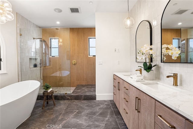 bathroom featuring vanity and independent shower and bath