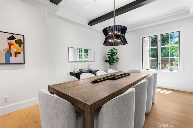 dining room with beam ceiling, crown molding, light hardwood / wood-style flooring, and an inviting chandelier