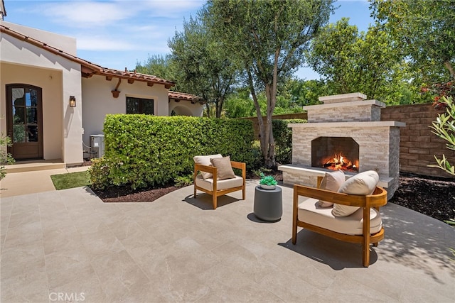 view of patio / terrace with an outdoor stone fireplace