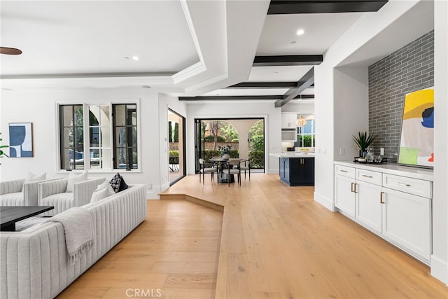 living room featuring beam ceiling, light hardwood / wood-style flooring, and coffered ceiling