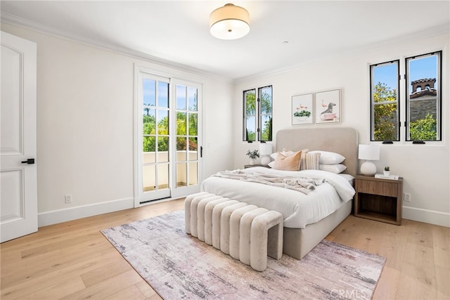 bedroom with access to exterior, light hardwood / wood-style flooring, and ornamental molding