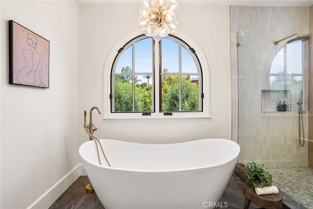 bathroom featuring separate shower and tub and a chandelier