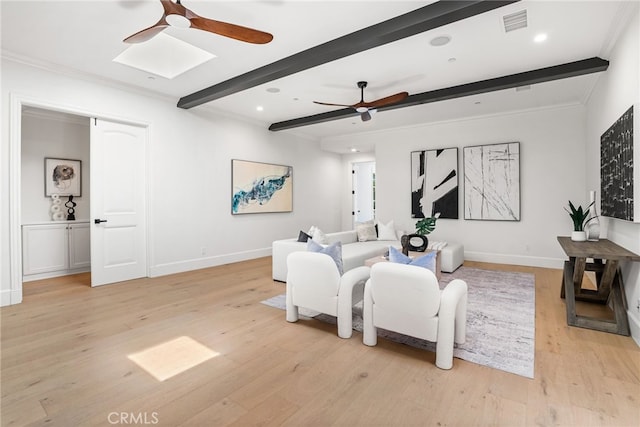 living room with beam ceiling, light wood-type flooring, and crown molding