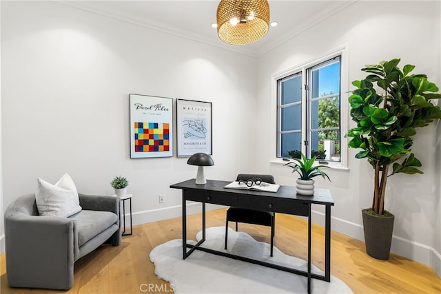 office space with ornamental molding and light wood-type flooring