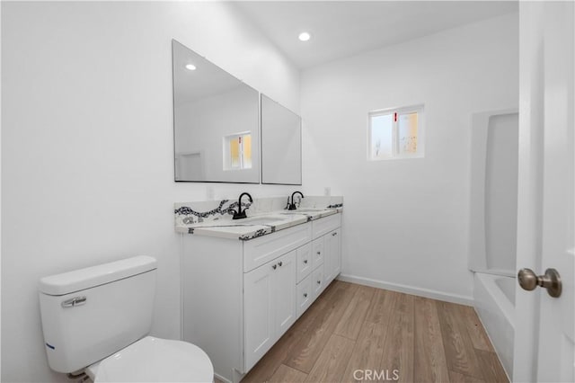 bathroom featuring hardwood / wood-style floors, vanity, and toilet