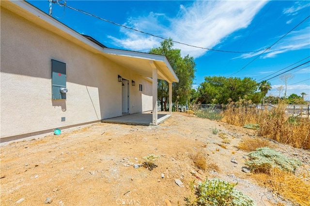 view of side of property with a patio