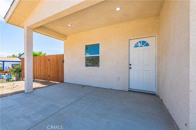 property entrance featuring a patio