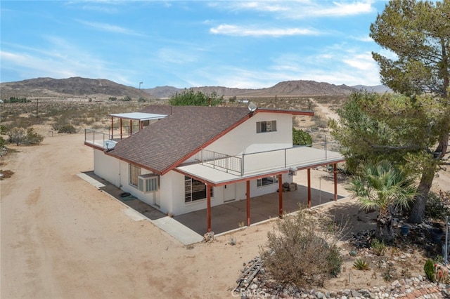 rear view of house featuring a mountain view