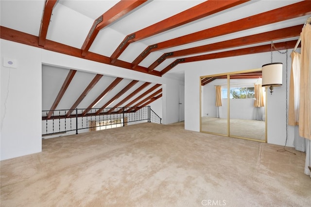 unfurnished living room with lofted ceiling with beams and carpet