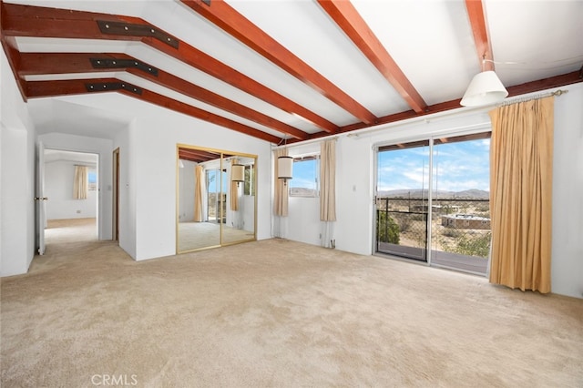 unfurnished living room featuring lofted ceiling with beams and light carpet