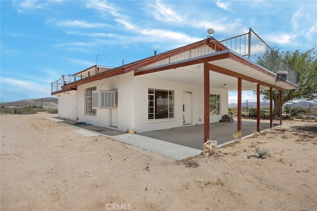 back of house featuring a patio and a balcony